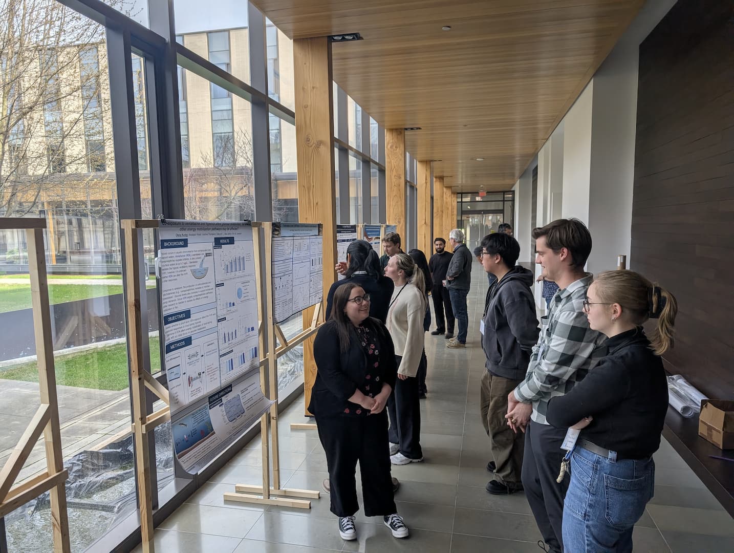 Image of attendees socializing around student posters
